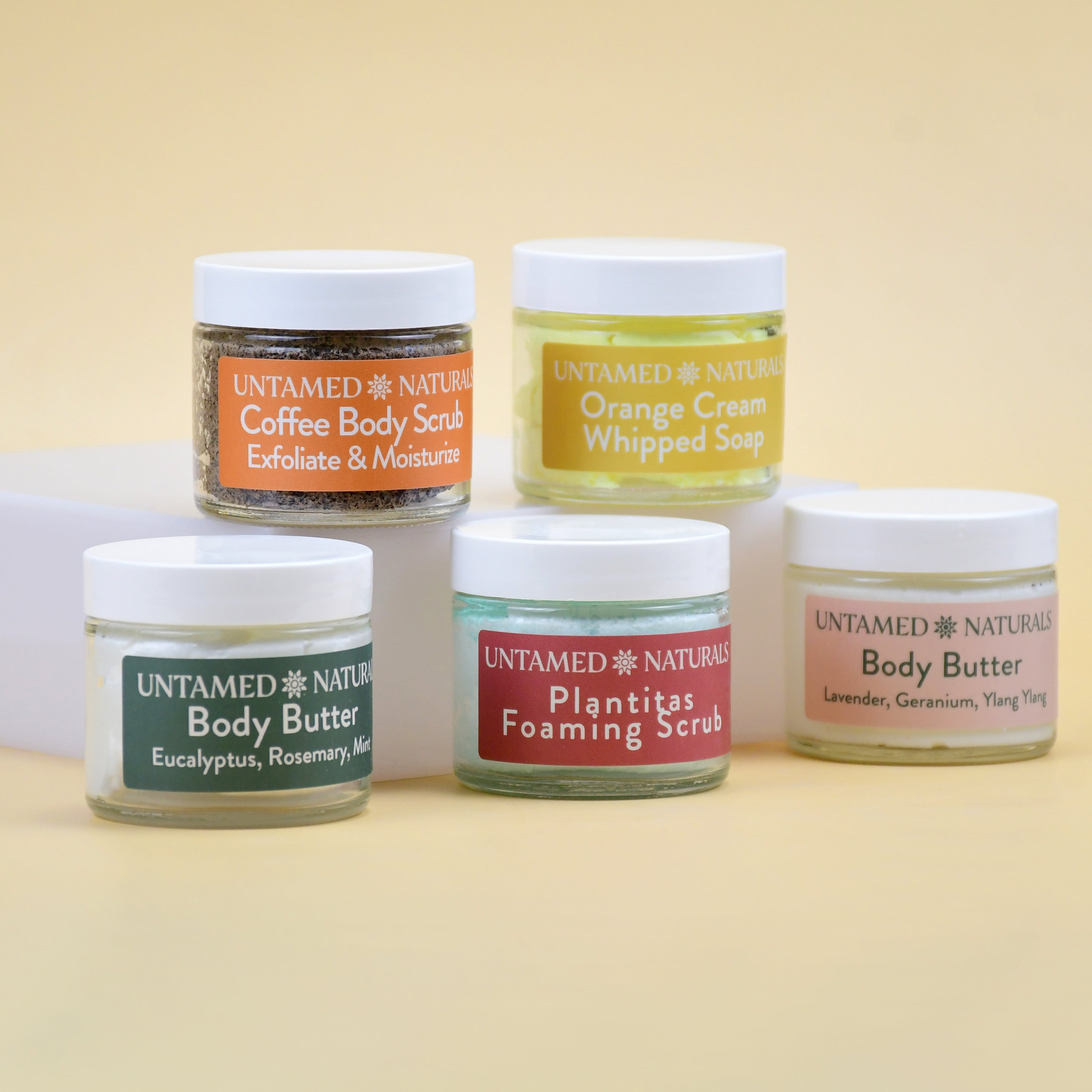 Collection of Untamed Naturals skincare products on a beige background