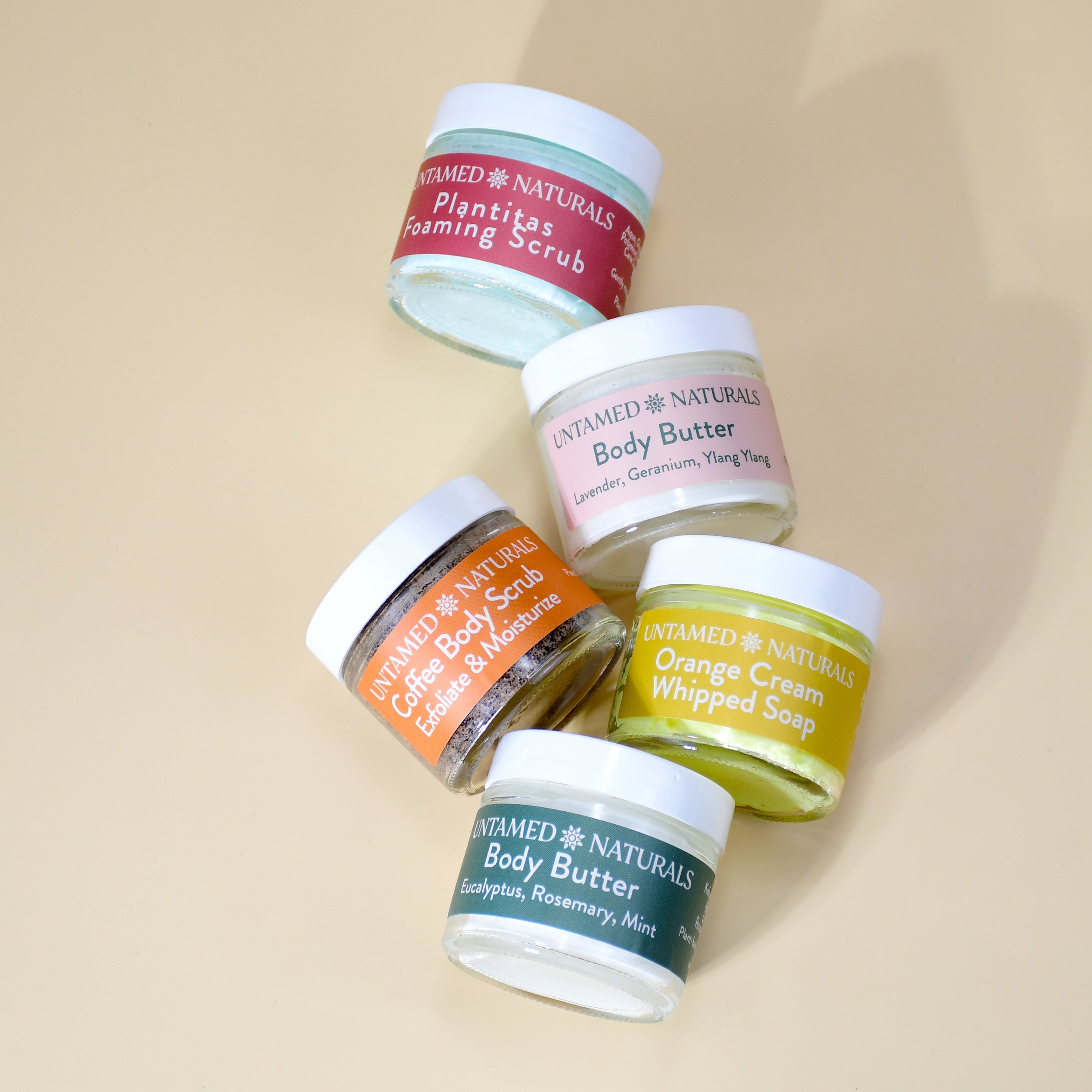 Collection of Unravel Naturals skincare products on a beige background