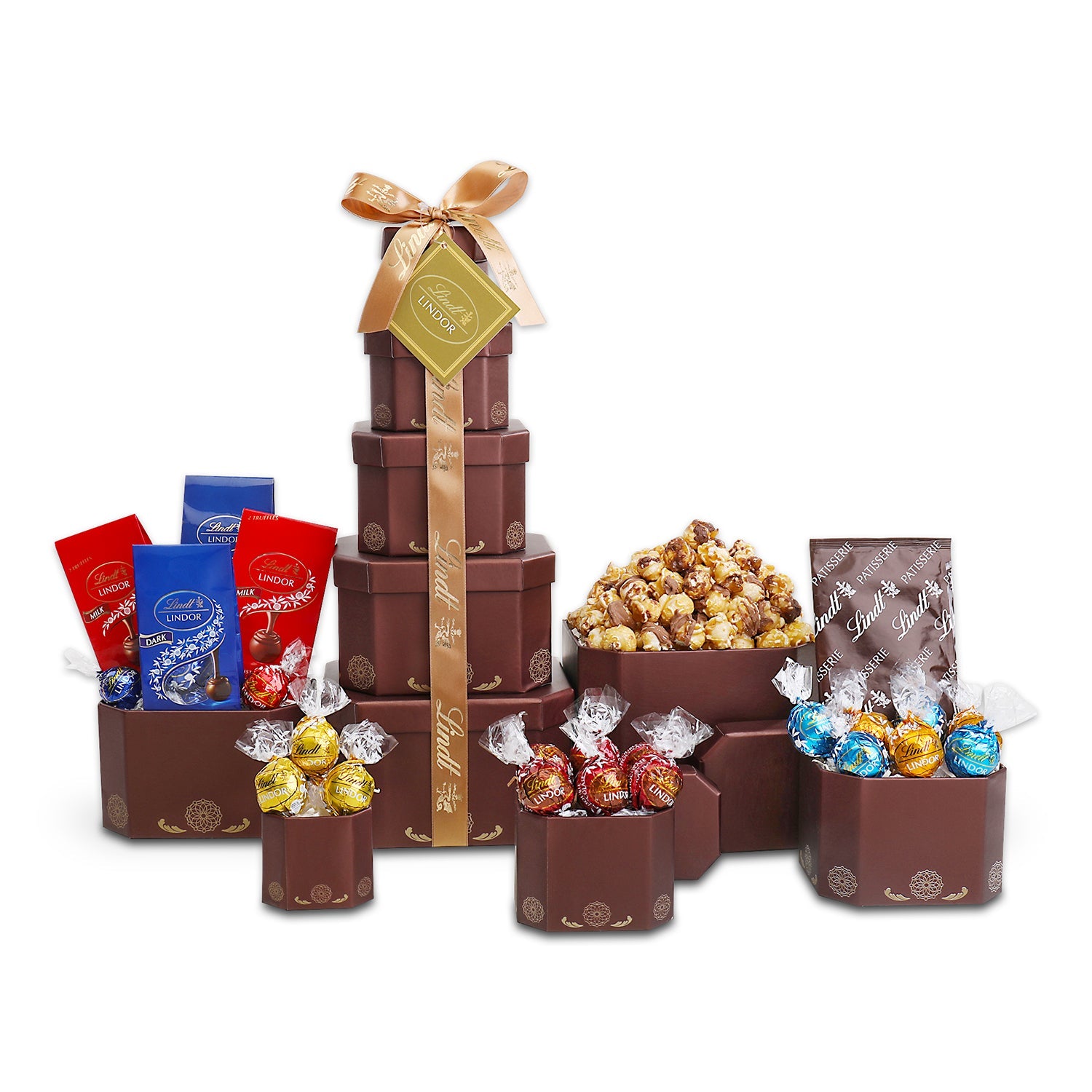 Gourmet gift tower with chocolates, popcorn, and candies on a white background