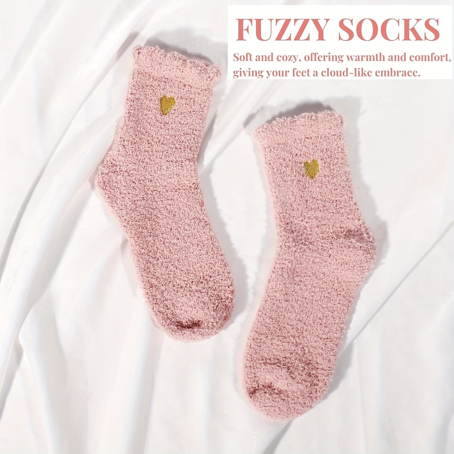 Pair of pink fuzzy socks with a heart design on a white background, labeled 'Fuzzy Socks'.