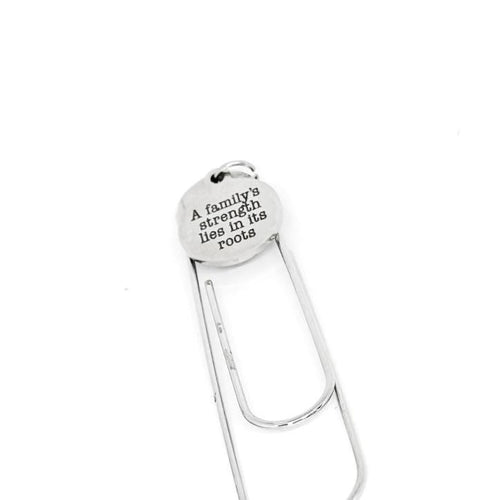 Silver paper clip with motivational quote on a white background